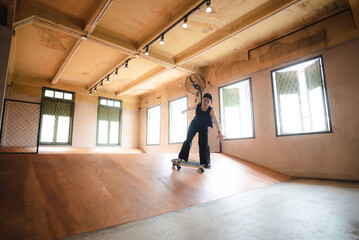 skater woman person playing skateboard in sport gym, young Asian woman are happy and fun with skateboarding lifestyle in city, teenage hipster female trendy fashion