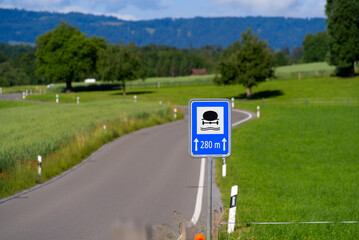 Country road with scenic rural landscape near village Forch, Canton Zürich, with traffic sign for protected groundwater zone on a sunny summer day. Photo taken June 8th, 2022, Forch, Switzerland.