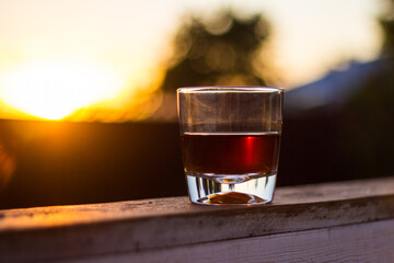 glass of whiskey at sunset
