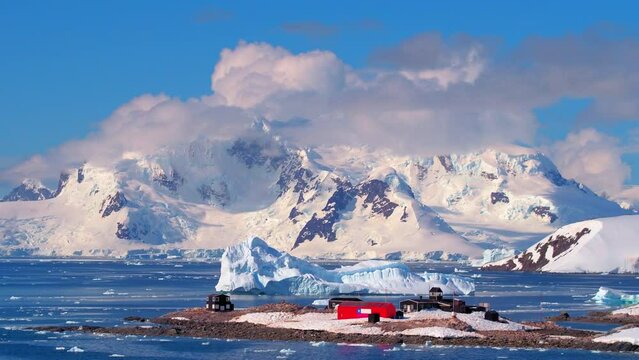 Log Cabins On Glacier Land Over Sea During Sunny Day - Antarctic Peninsula, Antarctica
