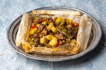 Traditional Turkish food; Meat with vegetables wrapped in greaseproof paper, kebab (Turkish name; Sebzeli kagit kebabi)