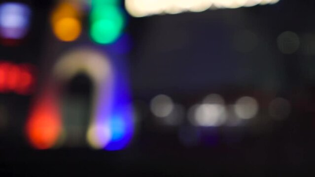 Defocus look of bangkok street at night. Car passing by with speed and beautiful light bokeh. Amazing Thailand nightlife. Using for green screen background scene.