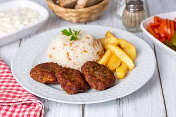 Traditional Turkish food; dry meatballs or inegöl meatballs with potatoes and rice pilav(Turkish name; Kuru kofte)