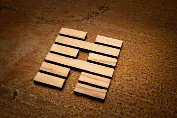 wooden Gene Key 39 i ging hexagram on rusty metal background human design