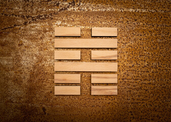 wooden Gene Key 39 i ging hexagram on rusty metal background human design