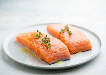 Fresh salmon fillet with herbs on a plate for delicious salmon steak.