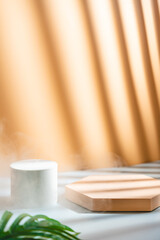 Cosmetics product advertising stand. Exhibition white podium with geometric shapes on a apricot color background with palm leaves and shadows. Empty pedestal to display product packaging. Mockup