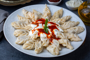 Georgian Dumplings Khinkali with Meat, Tomato Sauce and Spices -Hingel. (or Cerkes manti)