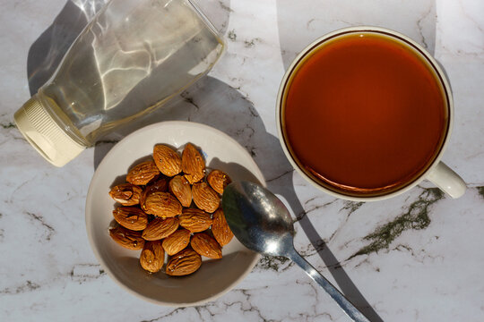 Almonds in chicory syrup and tea. View from above.