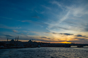 Fototapeta na wymiar Silhouette of Istanbul at sunset. Suleymaniye Mosque and Eminonu district