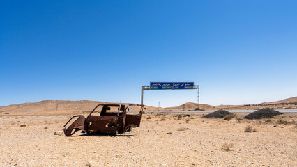 Road to Palmyra, from Damascus, in Syria. Wrecked car by the road.