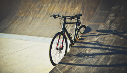 Fototapeta na wymiar gravel bike is stand in skatepark in warm light