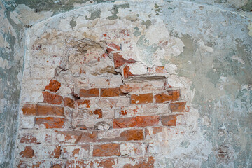 Destroyed wall in an ancient red brick building