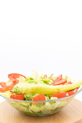 Fresh salad with tomato letuce and paprika served in the bowl with white background