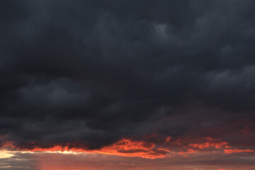 Fototapeta na wymiar Thunderclouds with breaking rays sun at sunset.