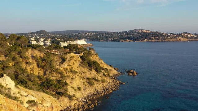 Aerial shot flying over coastal cliffs towards Costa de la Calma and Santa Ponsa, Mallorca, Spain