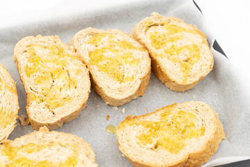 Baked bread with olive oil on the baking pan