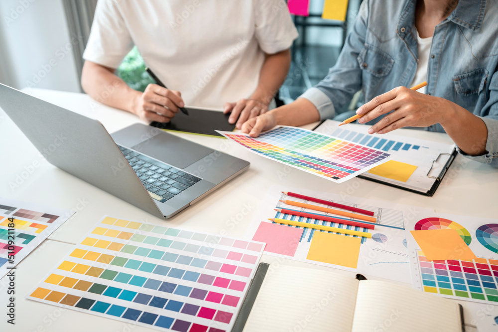 Poster Team of creative graphic designer working on color swatch samples chart for selection coloring in inspiration to create new collection at workplace