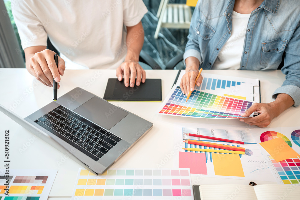 Poster Team of creative graphic designer working on color swatch samples chart for selection coloring in inspiration to create new collection at workplace