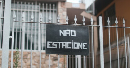 Sign NO PARKING outside home gate in brazilian portuguese NAO ESTACIONE