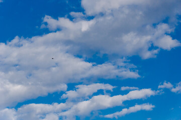 Fototapeta premium White and gray clouds in sun light on the blue sky perfect for the background. Landscape of beautiful blue sky with fluffy clouds