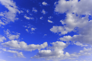 White and gray clouds in sun light on the blue sky perfect for the background. Landscape of beautiful blue sky with fluffy clouds