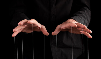 Man hands with strings at fingers. Manipulator controlling, exploiting person, showing power in...
