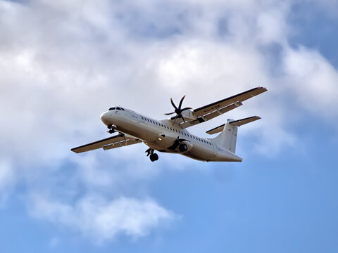 SOUTHEND-ON-SEA, ESSEX - AUGUST 06, 2017:  Stobart Air ATR 72 twin-engine turboprop aircraft against shortly after take-off against blue sky and clouds