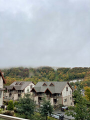 Fototapeta na wymiar mountain view on a foggy autumn day from a village