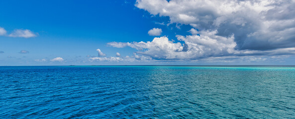 Beautiful sky and blue sea. Idyllic nature panoramic seascape, ocean lagoon dreamy cloudy sunny tropical sea view. Amazing nature panorama. Summer seaside, beach waves. Peaceful, tranquil surf  © icemanphotos