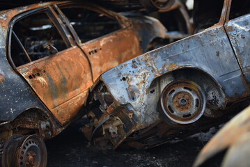 stack burnt out cars in close-up