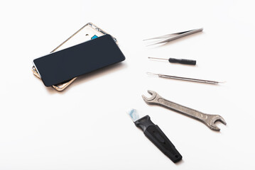 Flat lay image of dismantling the broken smart phone for preparing to repair or replace some...