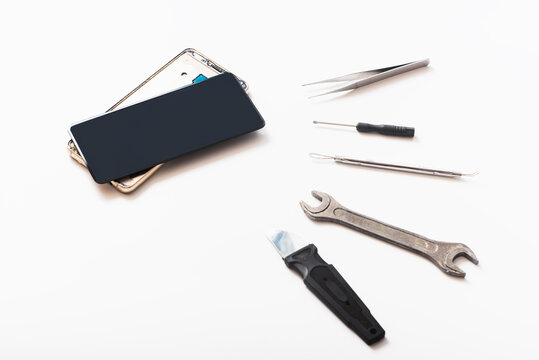 Flat lay image of dismantling the broken smart phone for preparing to repair or replace some components. isolated