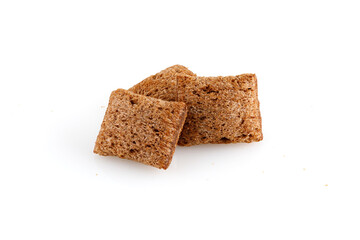 Set of chocolate pillows for breakfast isolated on white background. Brown choco cereal pads with vanilla, crispy flakes, healthy sweet snack. Close-up