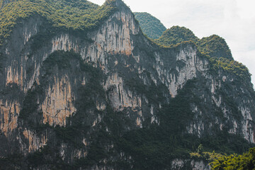 landscape photography of the mountains that are on the side of the li river in the guilin region in...
