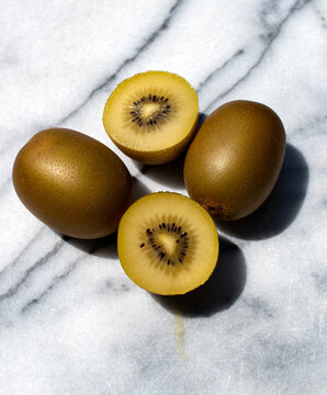 Golden Kiwi Fruit On A Marble 