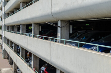 Multi-parking: concrete facade of a prefabricated building used for car garages, near shopping...