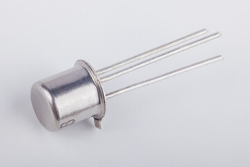 Old metal transistor BC107 on white background. Electronic component. Vintage semiconductor device. 