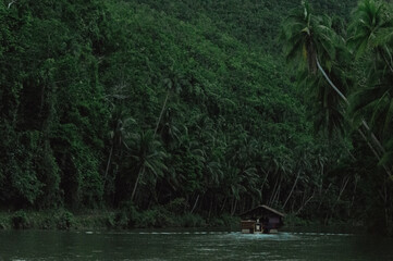 traditional raft boat on a jungle green river Loboc at Bohol island of Philippines