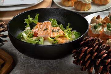 Salmon steak with salad to the New Year's table. New Year's decor, beautiful table.