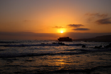 sunset on the beach with shipwreck 