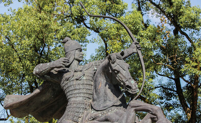 Fototapeta na wymiar Bronze statue of a Chinese archer mounted on a horse aiming