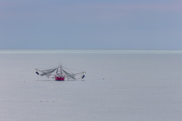 Fototapeta na wymiar Fishing Boat with Nets Deployed