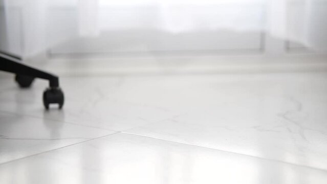 Close-up shot of office chair rolling on wheels