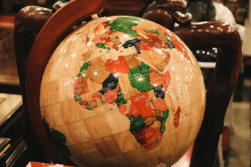 photography of a luxurious globe made of wood and marble