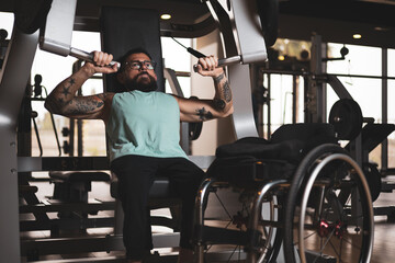 A middle aged man training inside a gym, working his pecs. Sports overcoming concept.