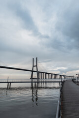 Fototapeta na wymiar Beautiful long Vasa da Gama bridge with a pier. Lisbon, Portugal