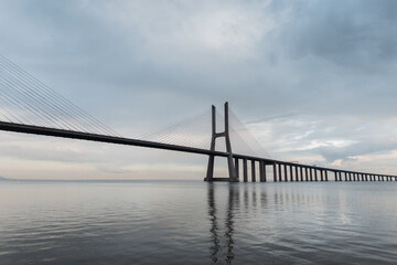 Amazing beautiful long Vasco da Gama Bridge on a cloudy day in Lisbon, Portugal