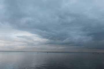 Amazing wide view of the sea with gray clouds in Lisbon, Portugal.