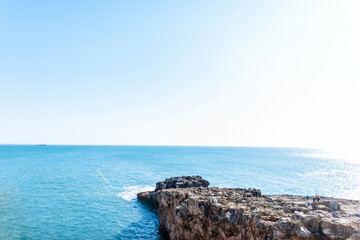 Beautiful blue ocean view with a cliff and a clear sunny horizon